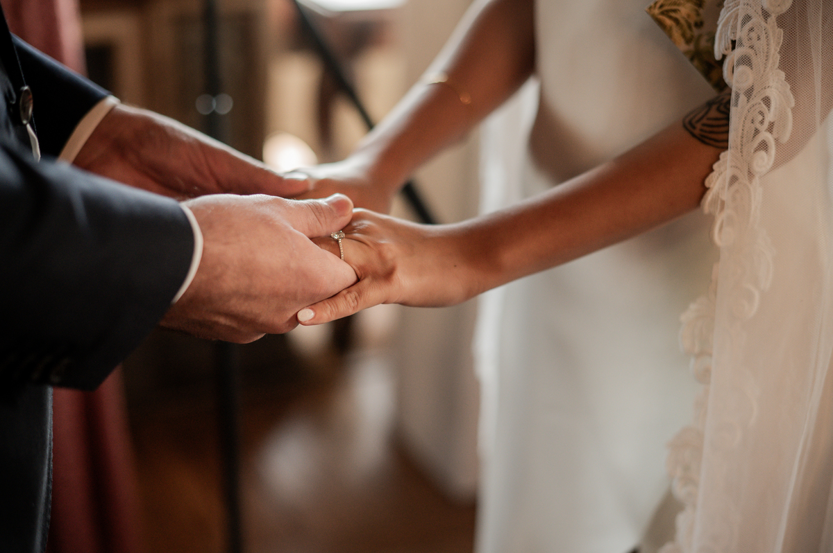 Bride-and-groom-holding-hands-while-getting-married