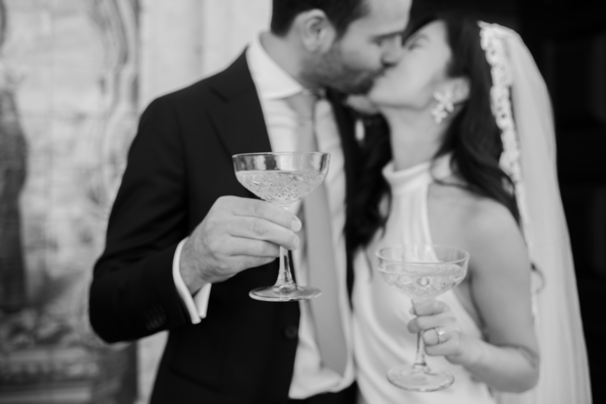Bride-and-groom-kiss-during-the-cocktail-party-drinks-reception