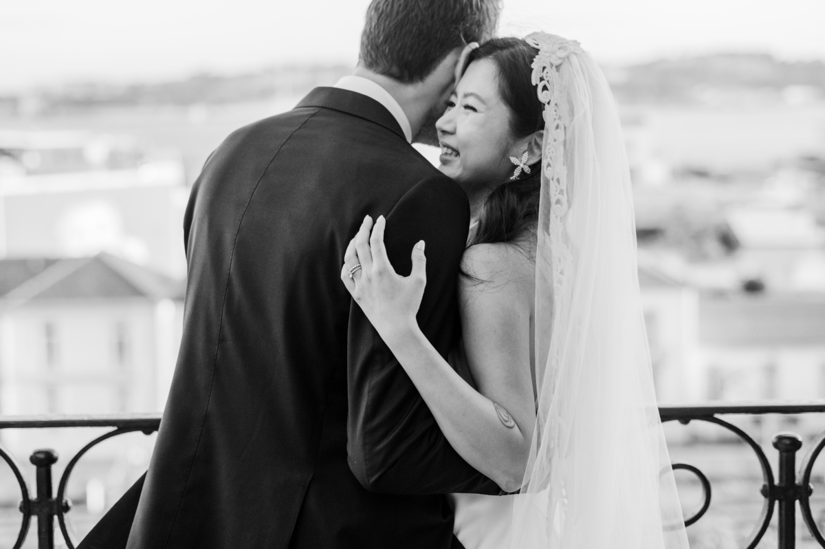 Bride-smilling-while-holding-groom