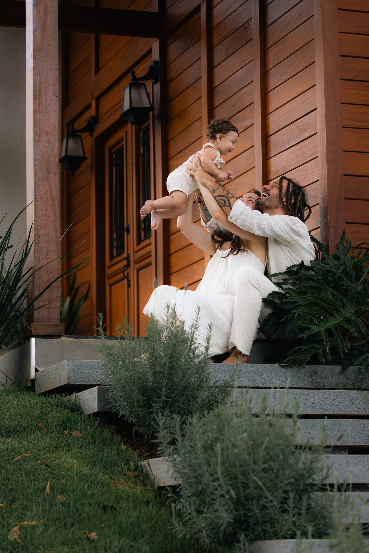 Pais felizes jogando filho pra cima