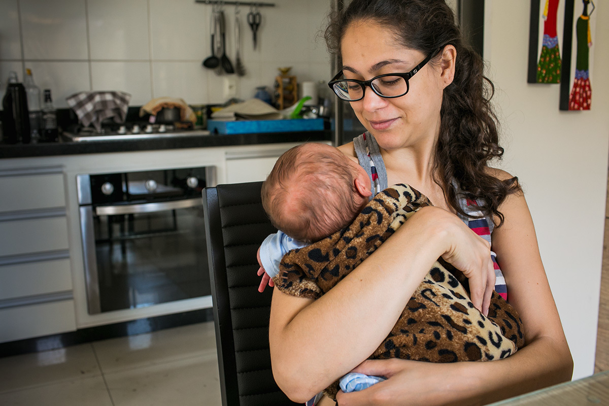 mãe admirando seu bebê após amamentar