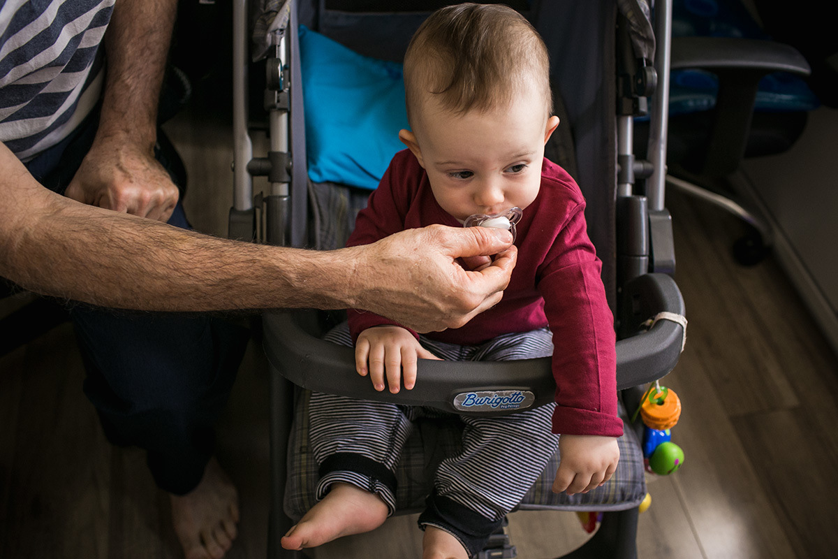 pai dando o bico para o filho que está com sono