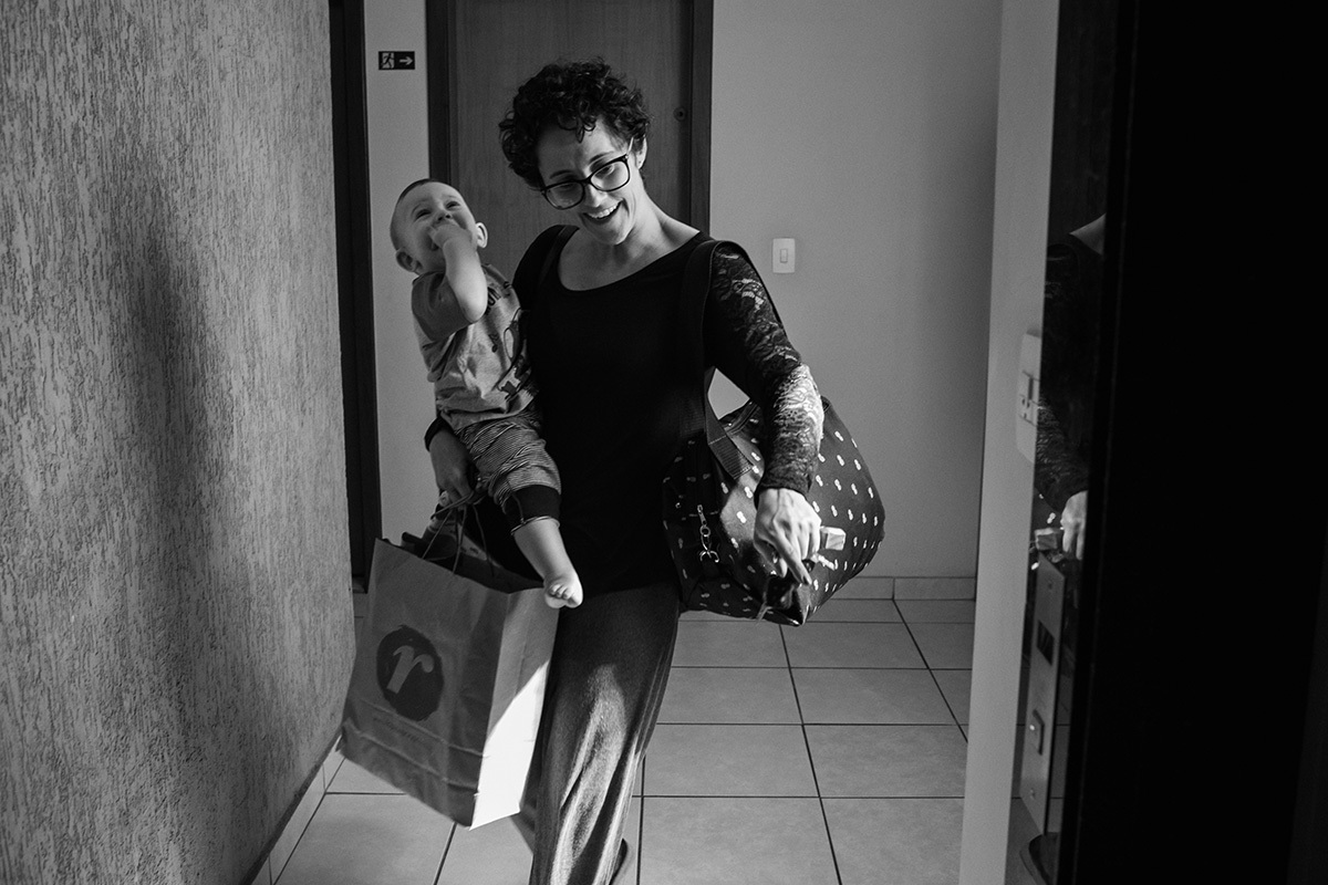 mãe saindo de casa com seu bebê, por Adriana Costa