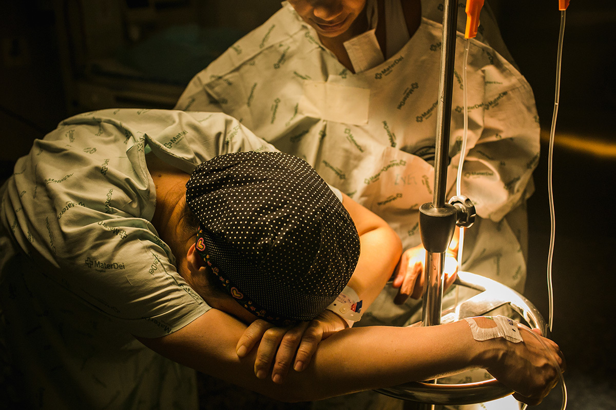 gestante sentindo contrações no trabalho de parto ao lado de sua doula, por Adriana Costa