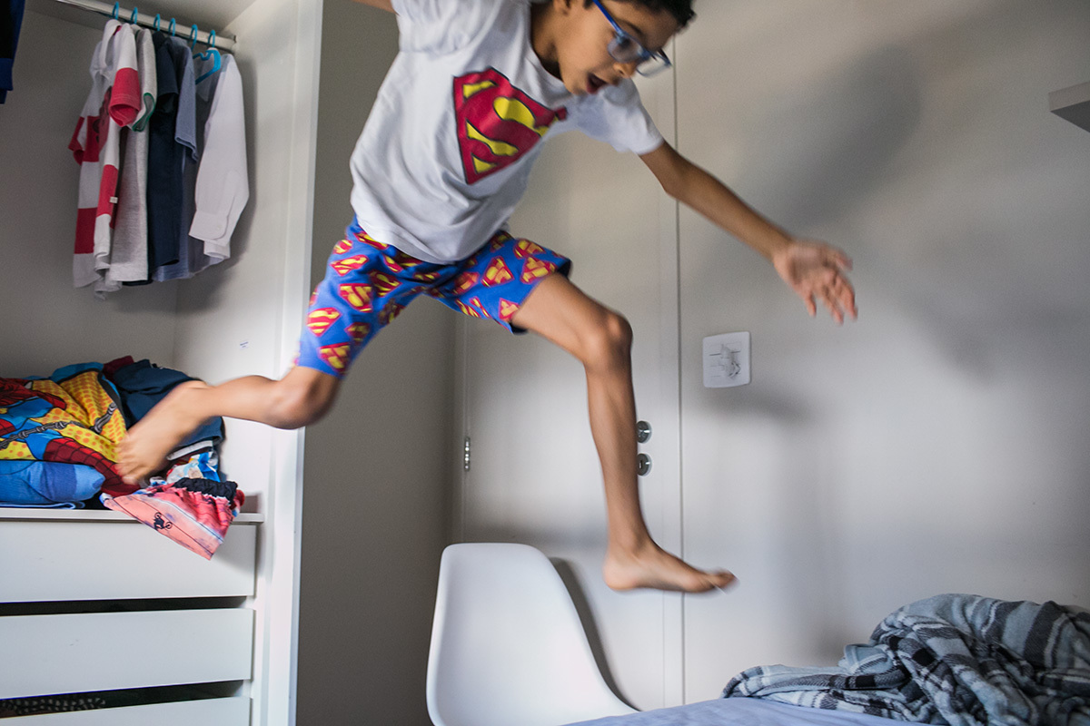 criança pulando para sair de dentro do armário, em foto de Adriana Costa