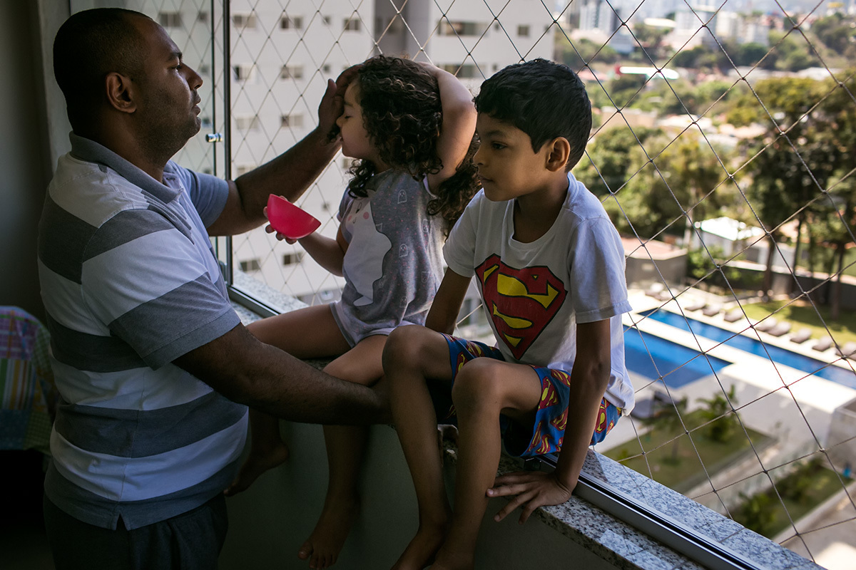 pai conversando com as crianças na varanda da casa