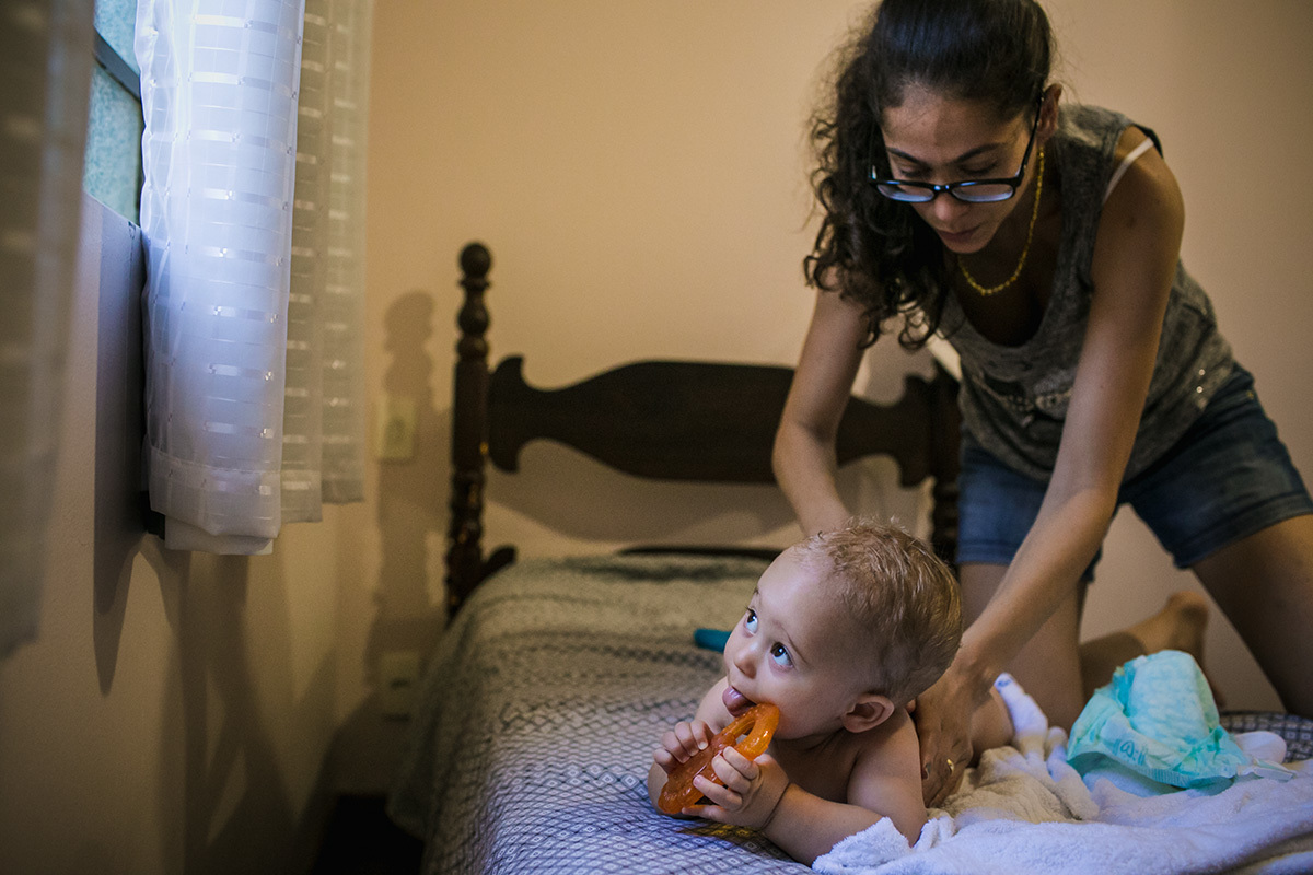 Adriana Costa fotografou mãe secando o bebê após o banho enquanto ele olha para a janela