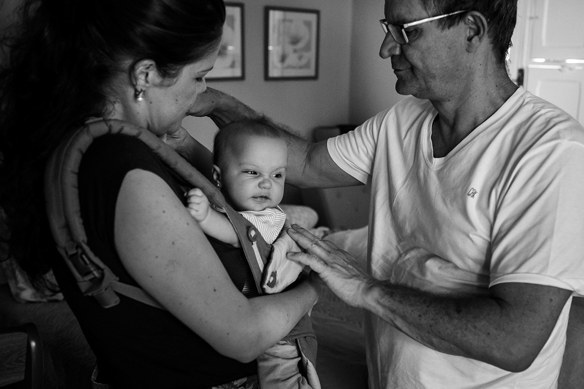 marido ajudando a esposa a ajustar no corpo o canguru para bebês