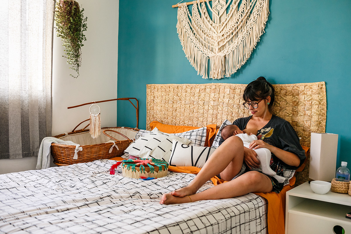 mãe amamenta tranquila seu bebê no quarto
