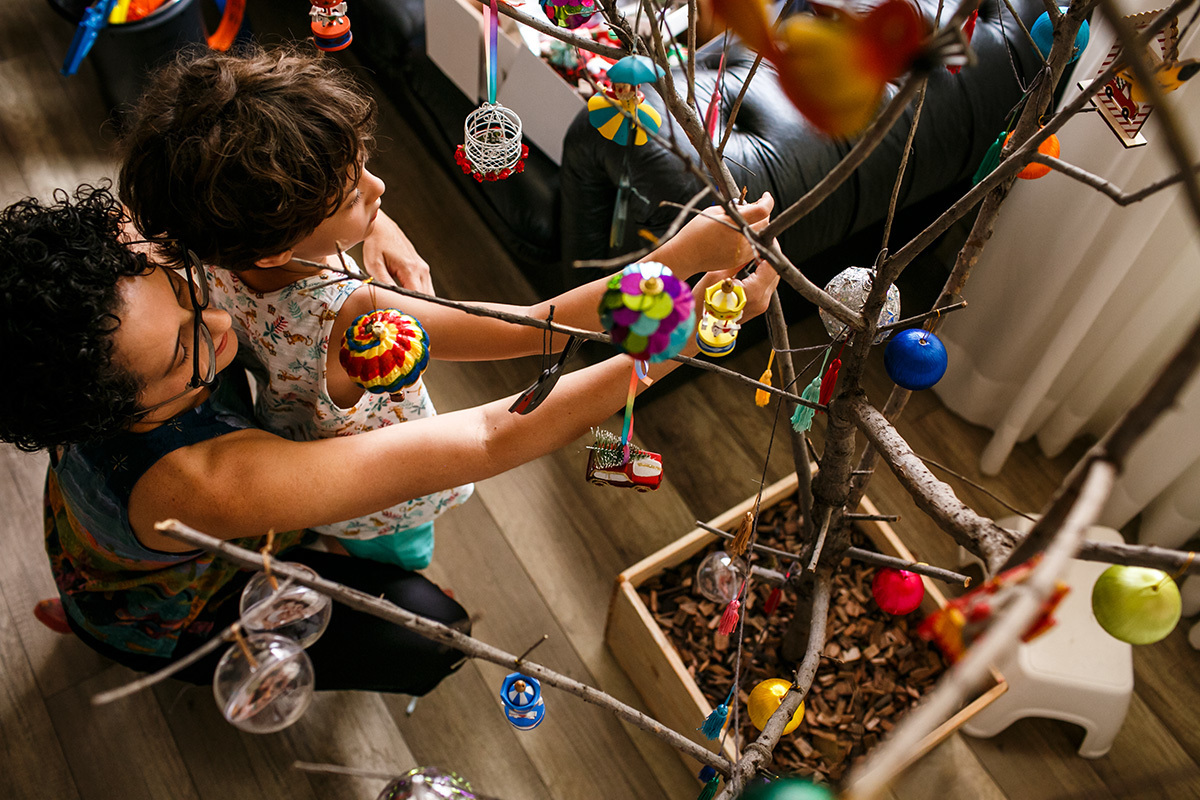 mãe e filho preparando a sua árvore de natal inusitada