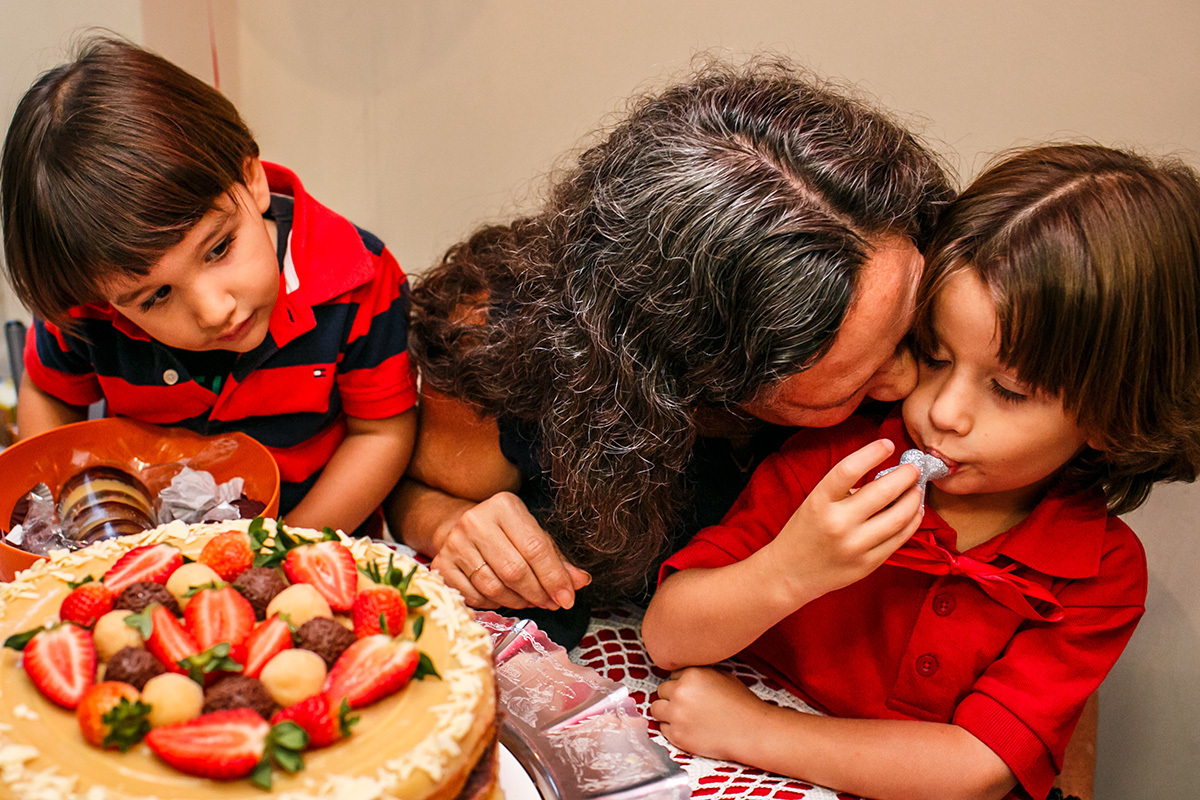 criança lambendo o bolo da base da vela