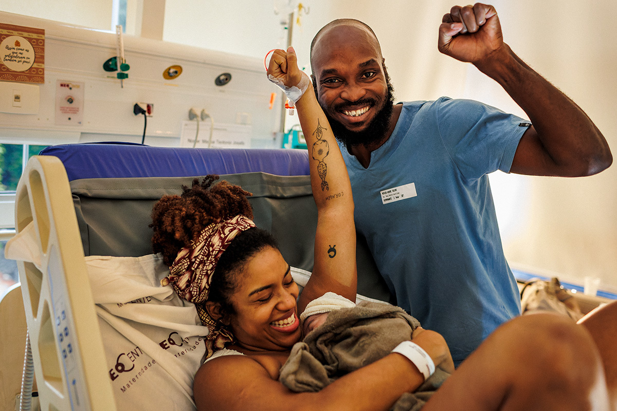 casal afro descendente comemora com alegria o nascimento de sua filha por um parto normal