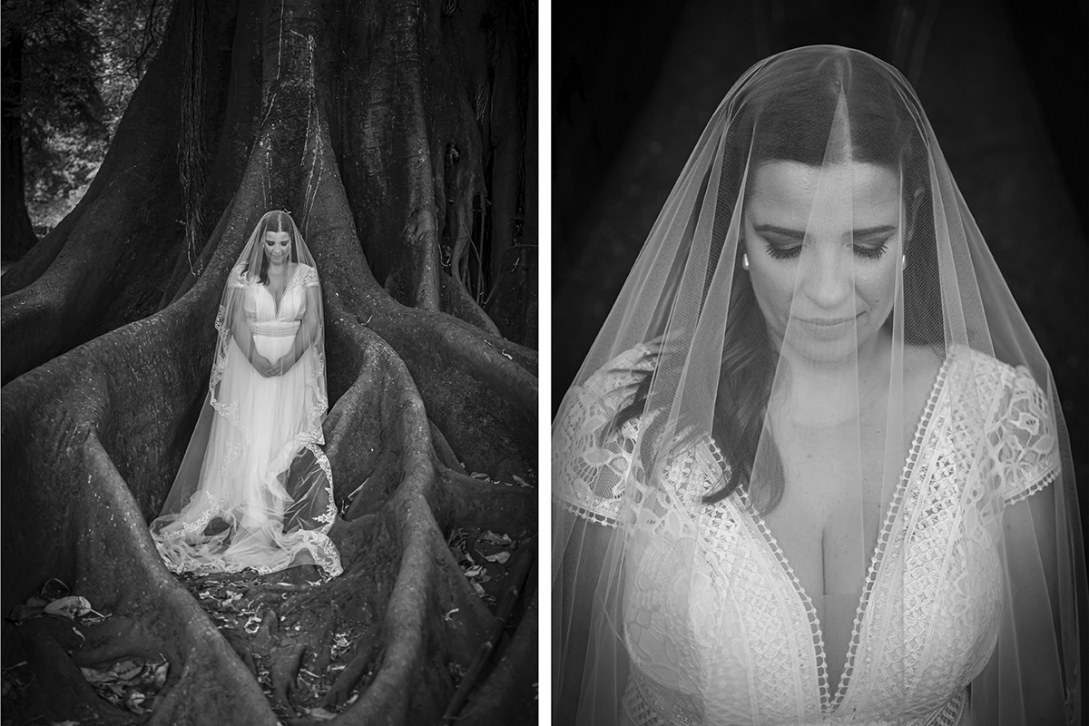 Entre as raízes que emergem da terra como braços antigos, Mónica surge envolta pelo véu, de cabeça baixa e mãos entrelaçadas. A preto e branco, esta imagem eterniza a delicadeza de um instante de introspeção.