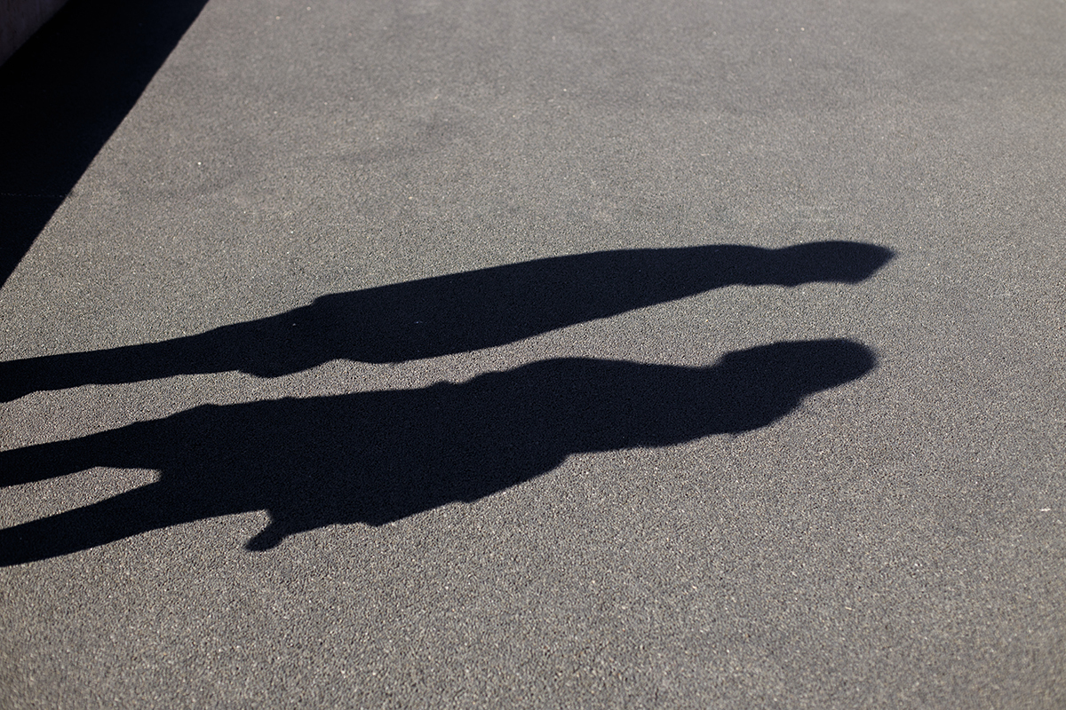 Apenas as silhuetas dos dois, frente a frente, como se o amor ganhasse forma na sombra.