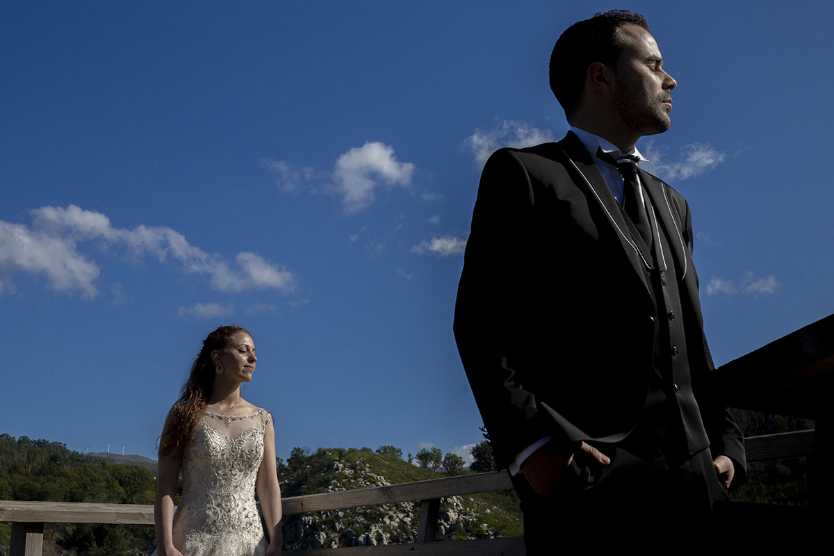 Aqui, o ângulo contrapicado revela Jorge em primeiro plano, de olhos fechados, com a luz do sol a acariciar-lhe o rosto. Atrás, Daniela repete o gesto, ambos envoltos numa aura de paz.