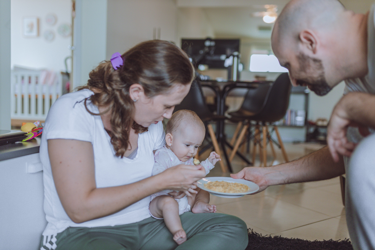 pais dando banana pela primeira vez para bebê em Florianópolis