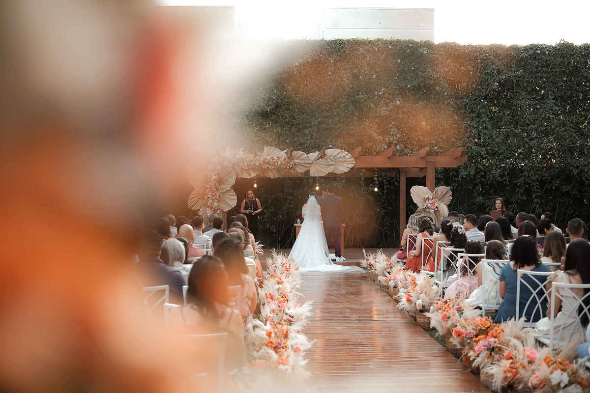 Momentos espontâneos dos noivos durante a cerimônia ao ar livre em Santa Luzia, Minas Gerais, mostrando a alegria e emoção do casamento.

