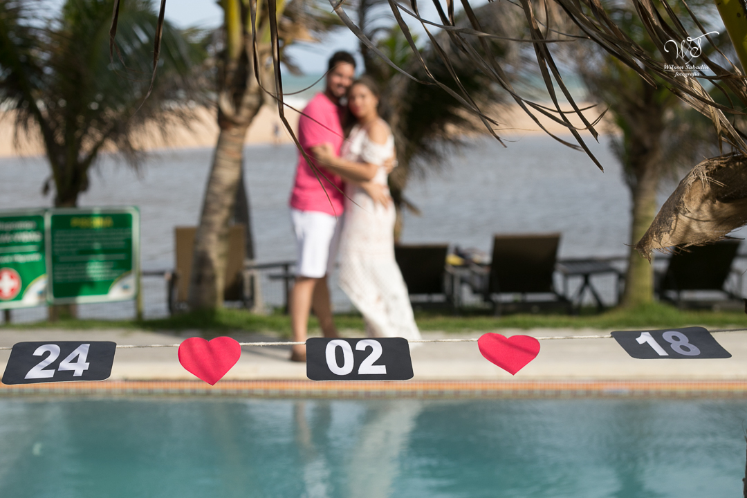 ensaio de casal na borda da piscina e com a data do casamento