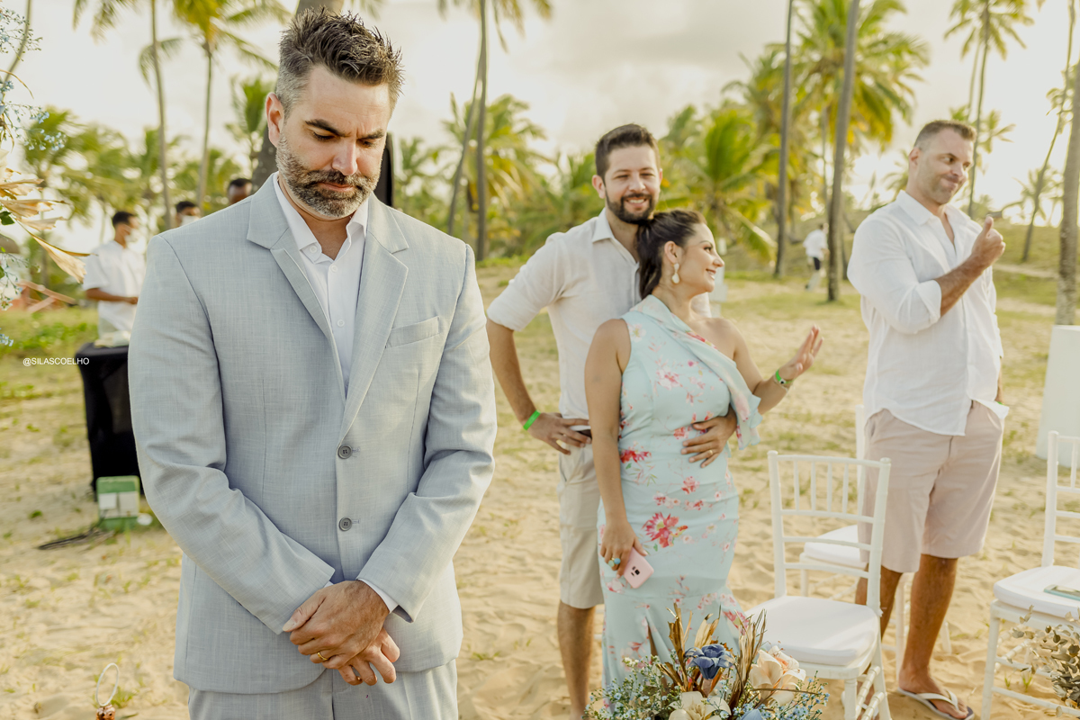 Noivo esperando a noiva entrar no casamento na praia frente ao mar na bahia