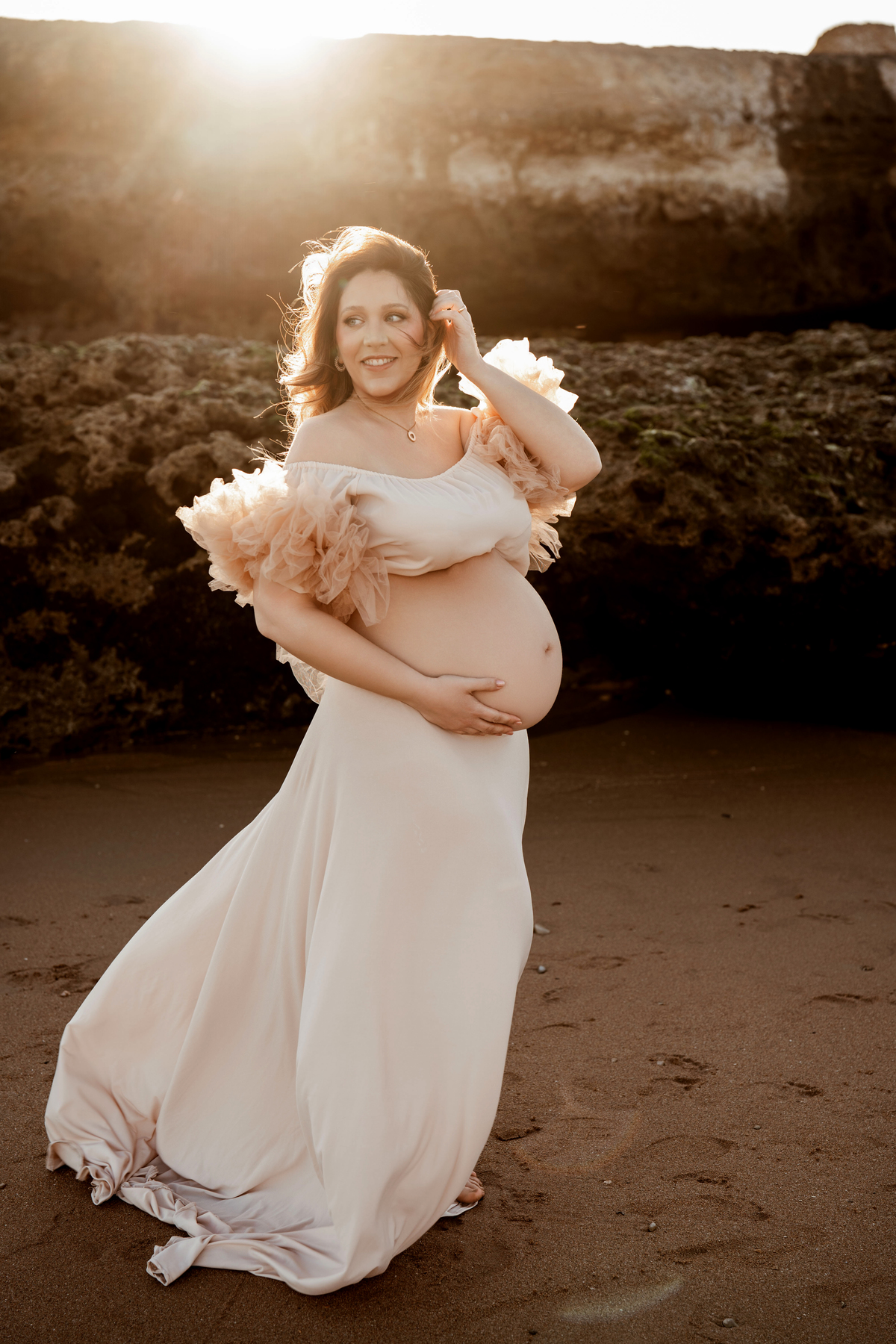pregnant woman at sunset beach Lisbon photoshoot