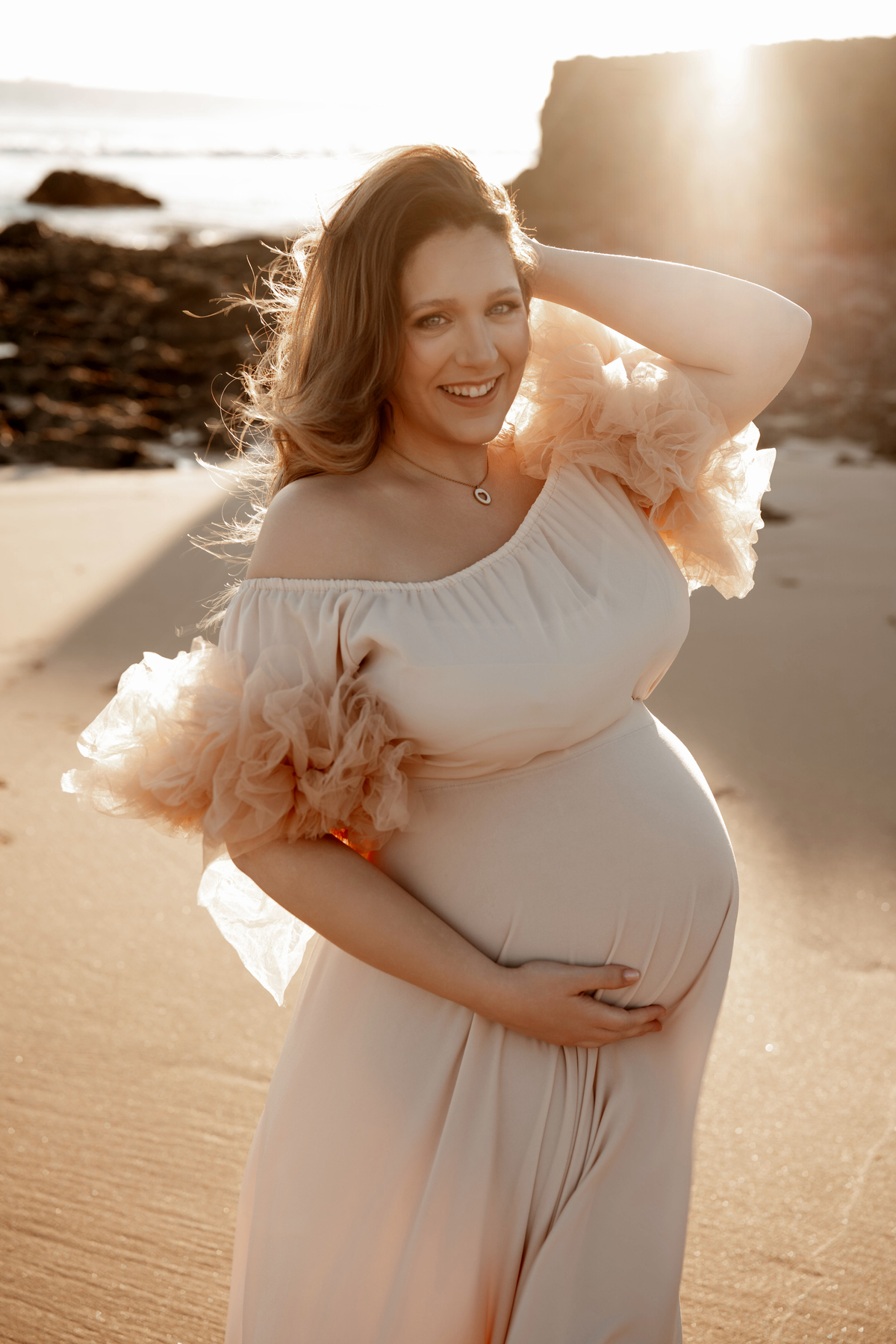 maternity photoshoot on the beach in Lisbon at sunset