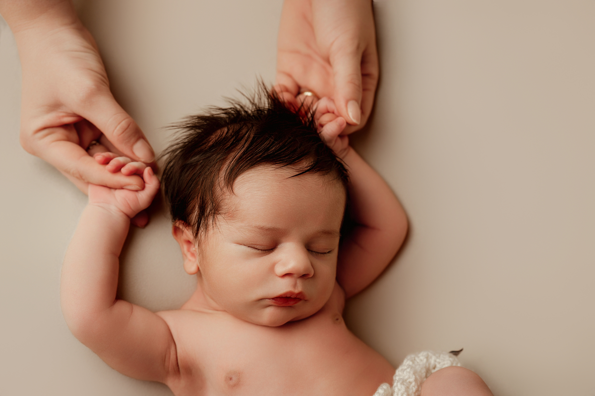 Recém-nascido em pose natural durante sessão newborn em Oeiras. Segurança e conforto são sempre a prioridade.