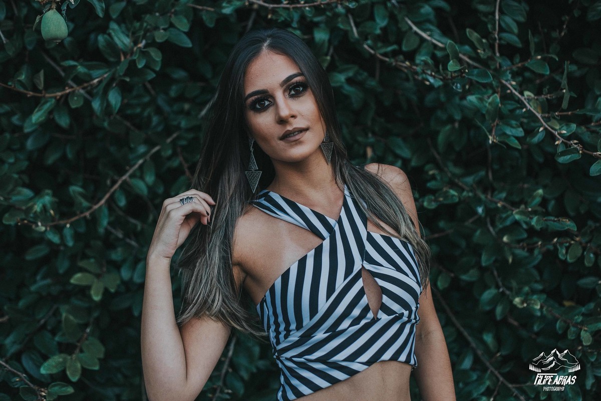 ensaio feminino em betim que a modelo esta olhando para o fotografo e mexendo no cabelo
