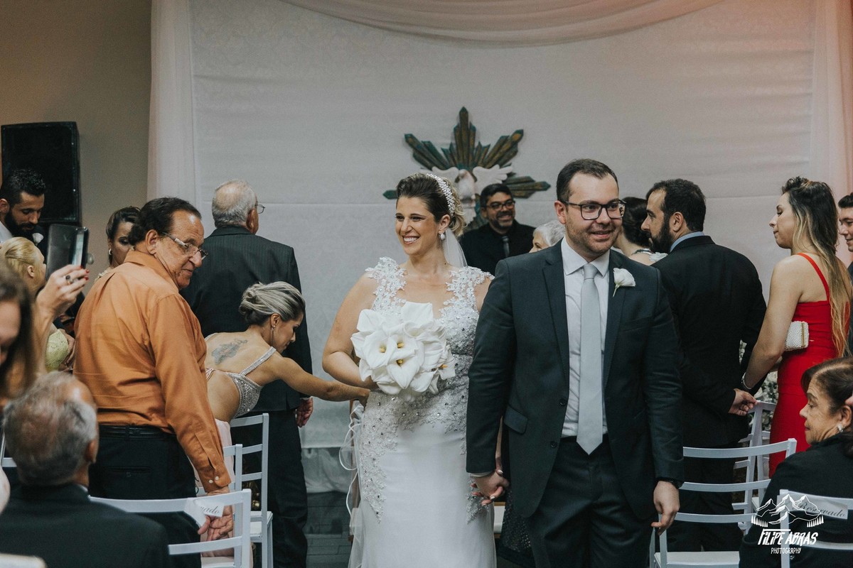 noivos saindo da cerimonia sorrindo