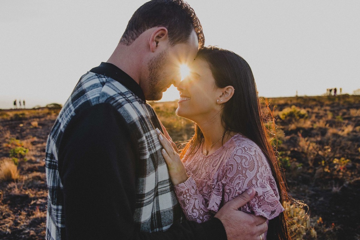 Noivos se olhando no por do sol no alto da serra do rola moça em um ensaio de pré casamento