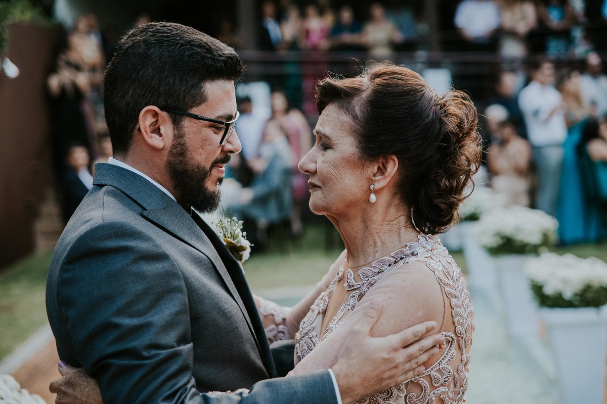 Mãe olhando para o filho no altar ao entrega-lo para o casamento durante o dia em BH