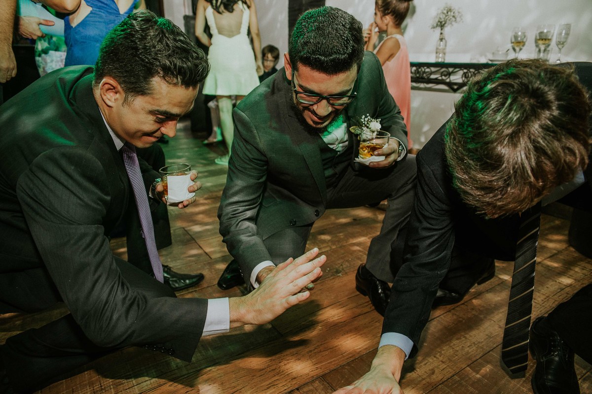 Noivo zuando com os padrinhos durante a recepção de casamento