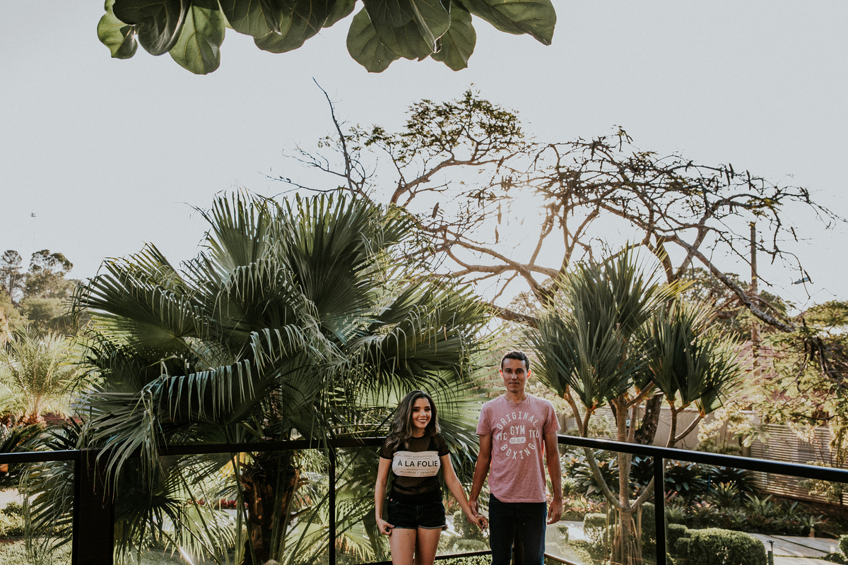 Retrato criativo de casal no por do sol no qual os dois estão de mãos dadas