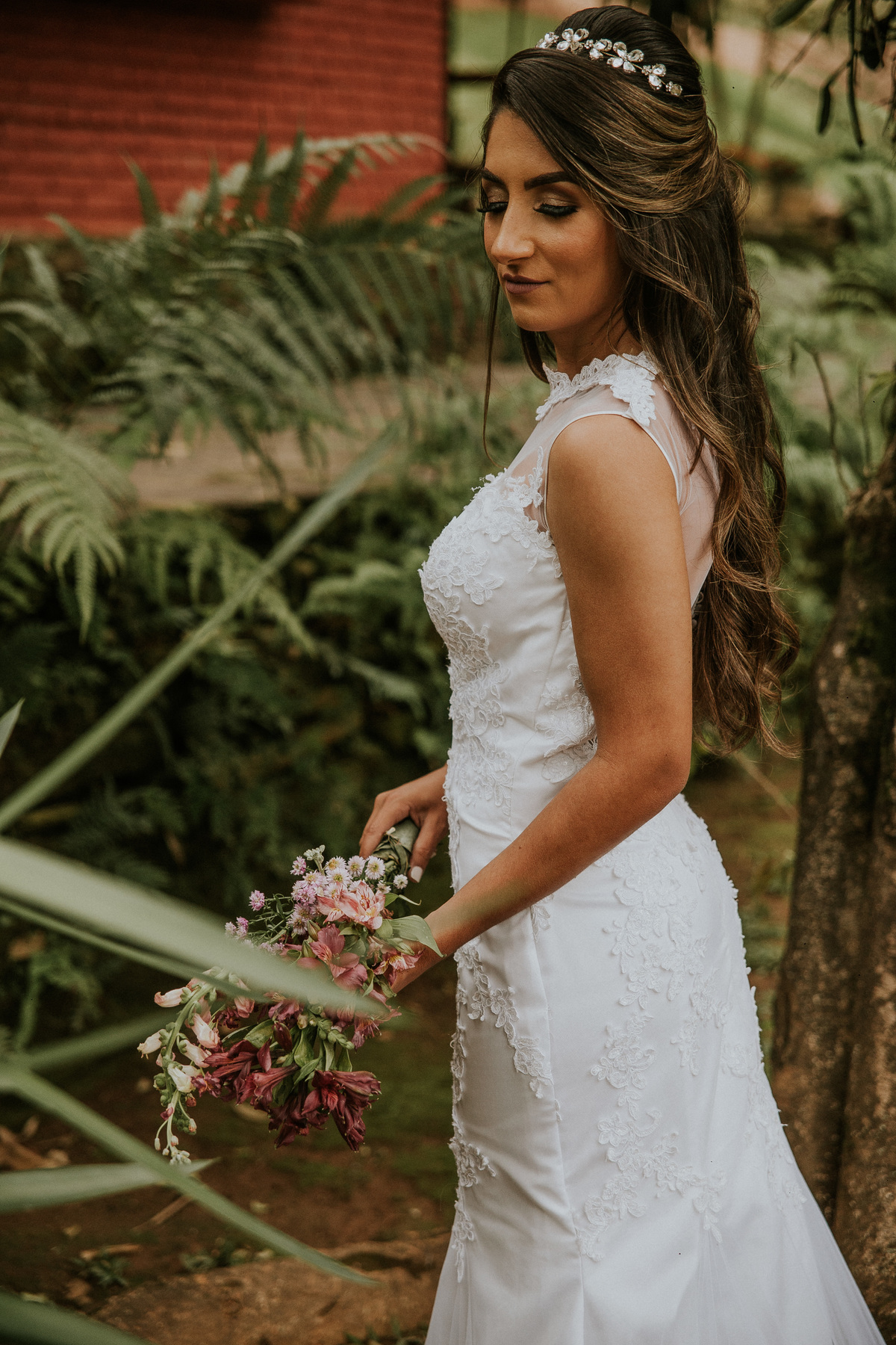 fotografia de oós casamento fazenda arraial velho em sabara no qual a noiva está de costas e segurando o seu buque de noiva