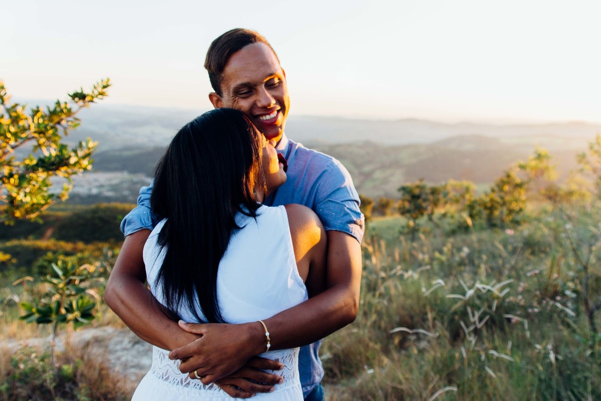 fotos no por do sol de recem casados, eles estão sorrindo e abraçados olhando um para o outro com um olhar apaixonado,