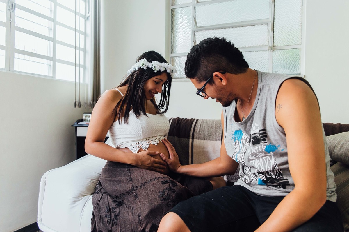 Pai acariciando a barriga da esposa gravida