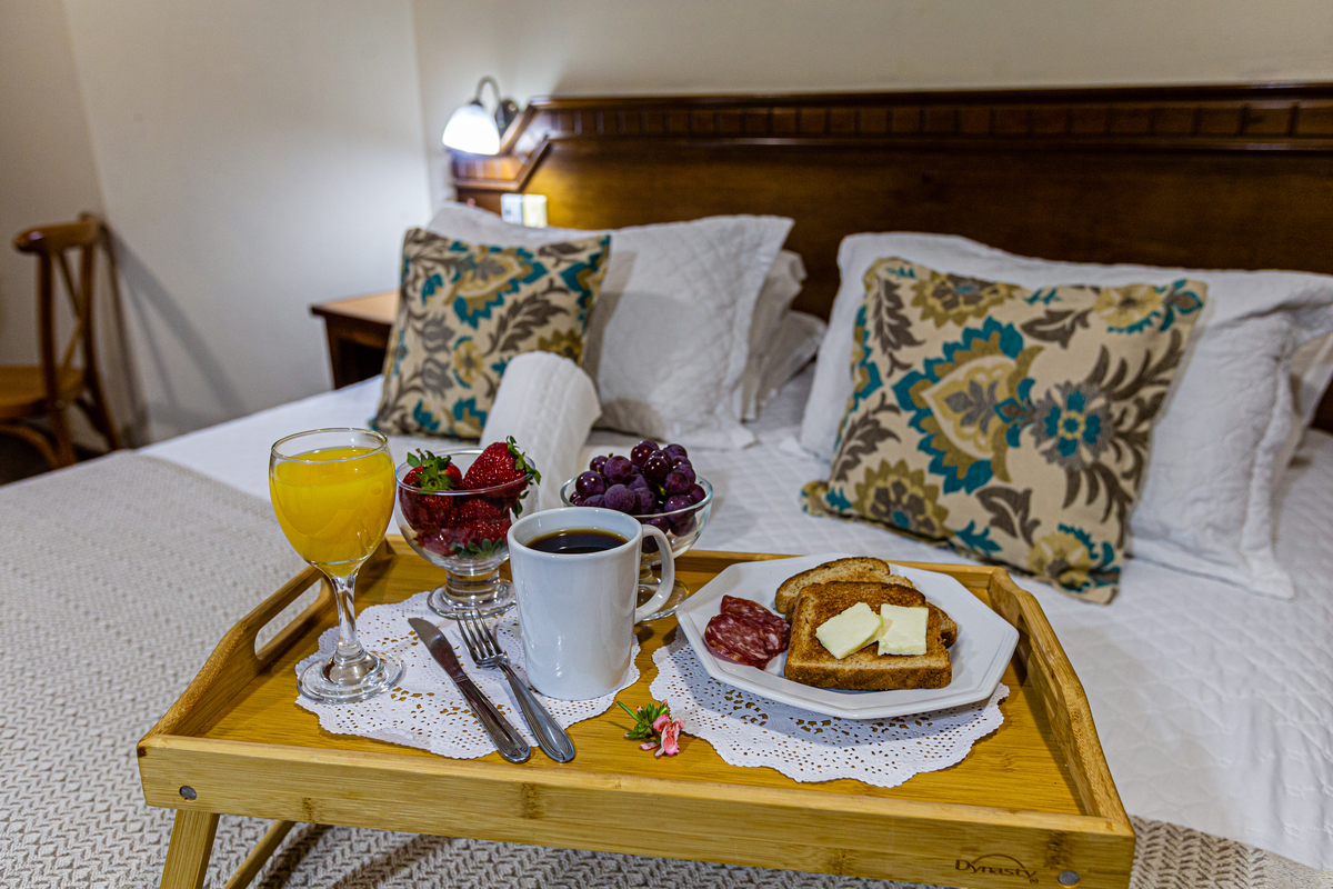 café e frutas na cama  na Pousada Bosque Canela. 