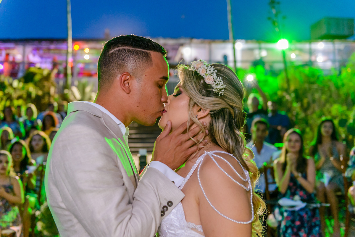 Beijo dos noivos na celebração do casamento realizado na praia de camboinhas no quiosque harmonia em Niterói, Rio de Janeiro - RJ