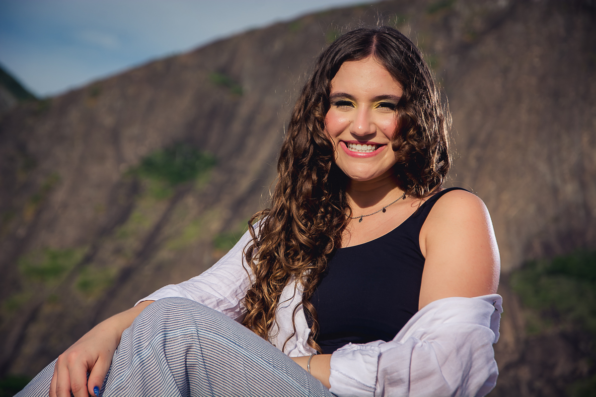 debutante sentada, sorrindo com iluminação lateral