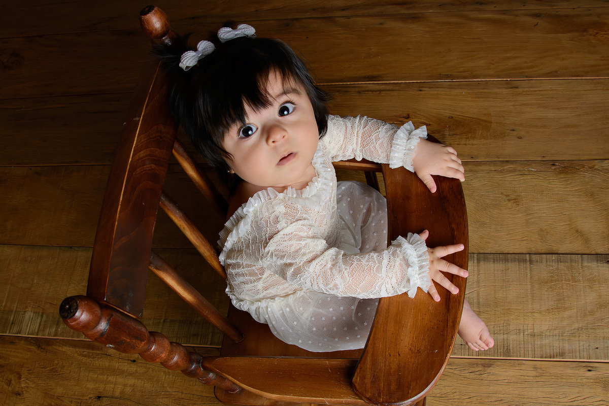 Ensaio fotográfico da Nina com 6 meses na cadeira de madeira