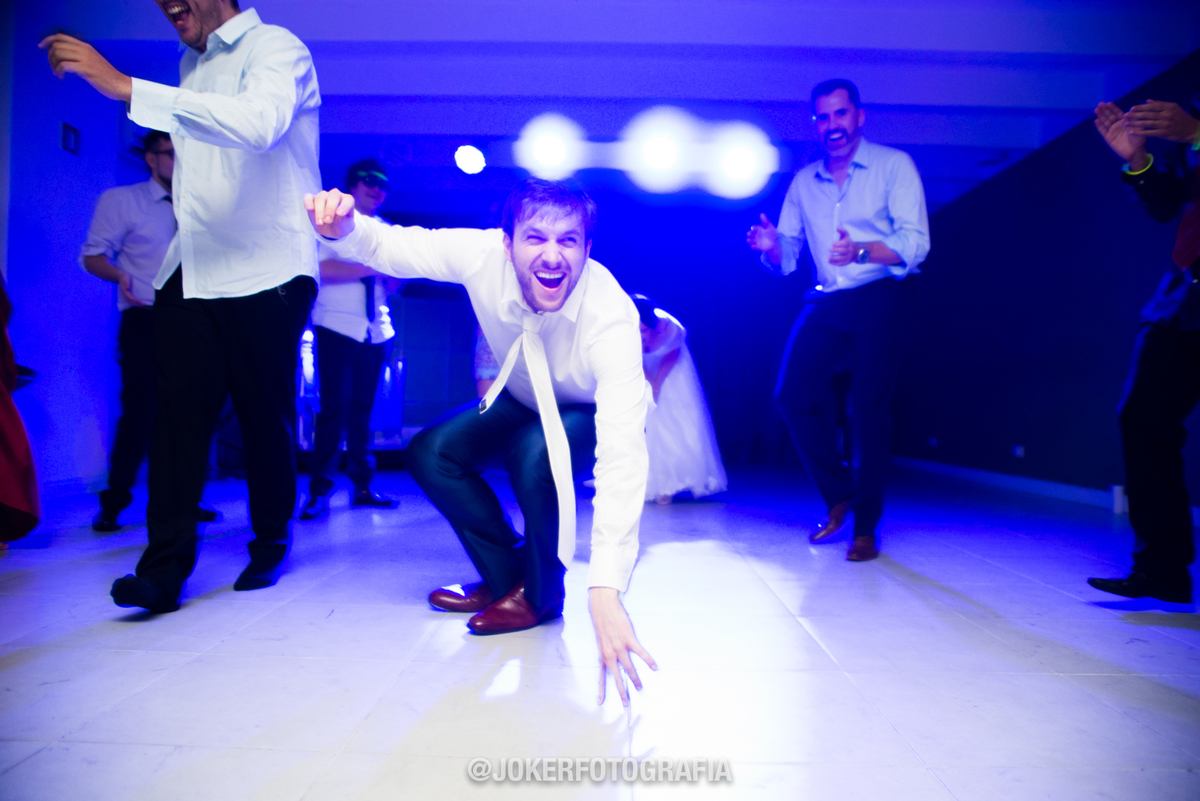 fotógrafo animado participa da pista de dança com os noivos