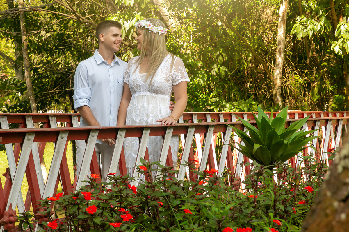 Noiva com coroa de flores olhando para noivo em parque lindo em ensaio pre wedding em nova friburgo no rio de janeiro