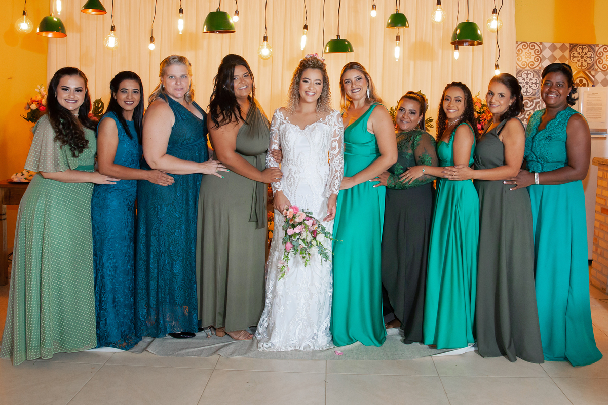 Noiva com vestido sereia, com as madrinhas vestidas com vestidos verde  e flores coloridas durante sessão de fotos em Casamento durante o dia ao ar livre  em Santo Antônio de Pádua no interior do Rio de Janeiro.