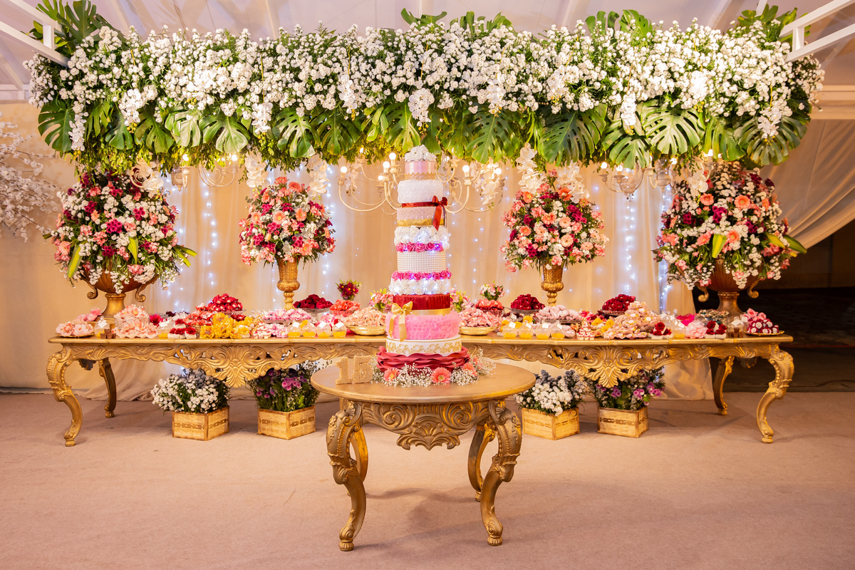 Decoração linda para festa de 15 anos em tons de vermelho e dourado com muitas flores naturais em maison saintec ecile  em Santo Antônio de Pádua interior do Rio de Janeiro.