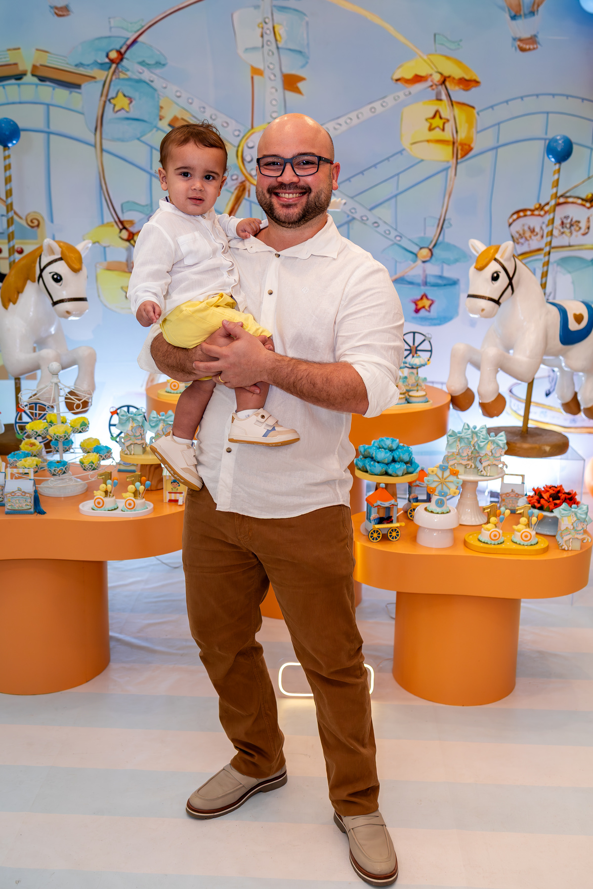 Pai Yann com filho Mateus 1 ano no colo festa Parque de Diversões