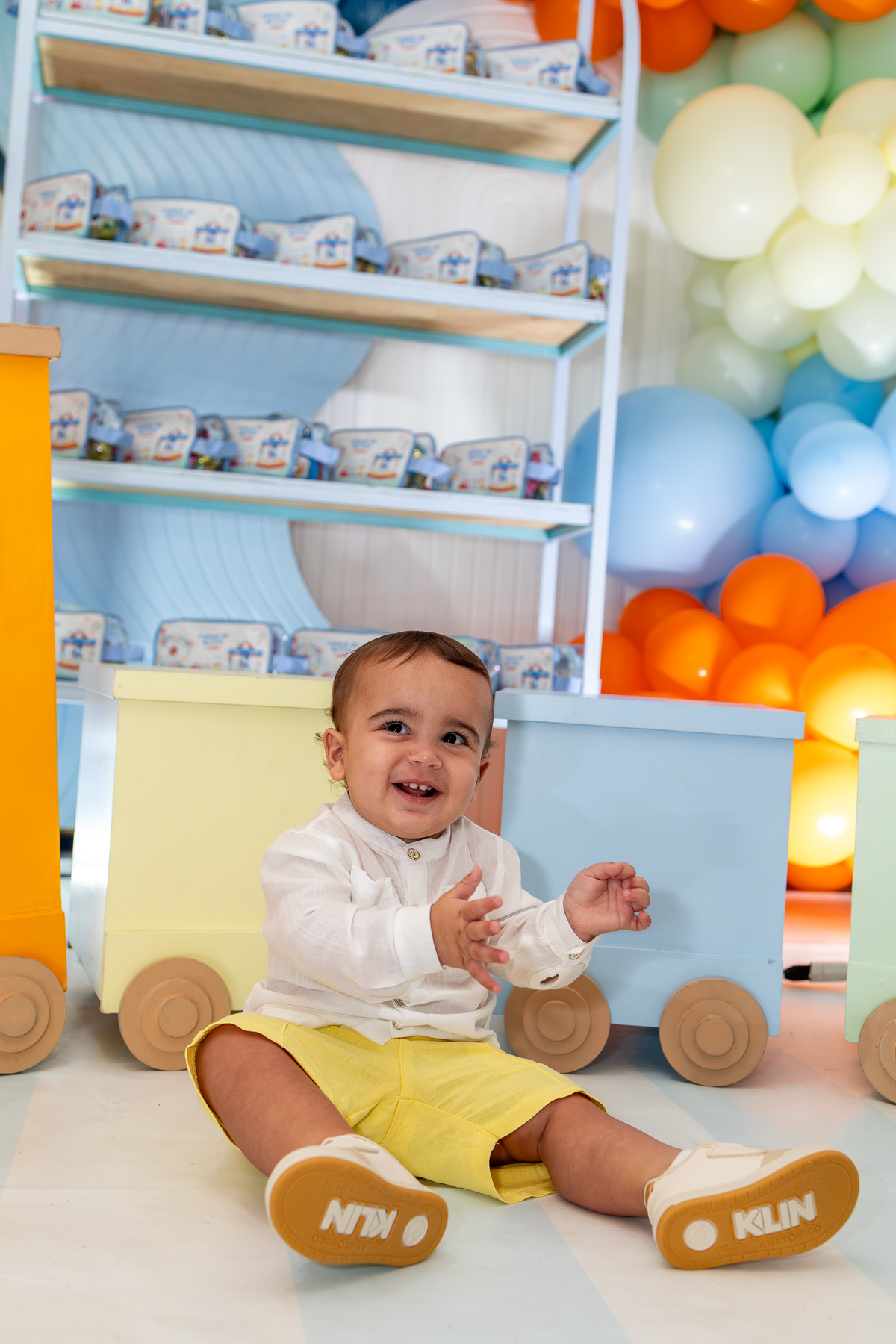 Mateus explorando decoração colorida festa Parque de Diversões 1 ano