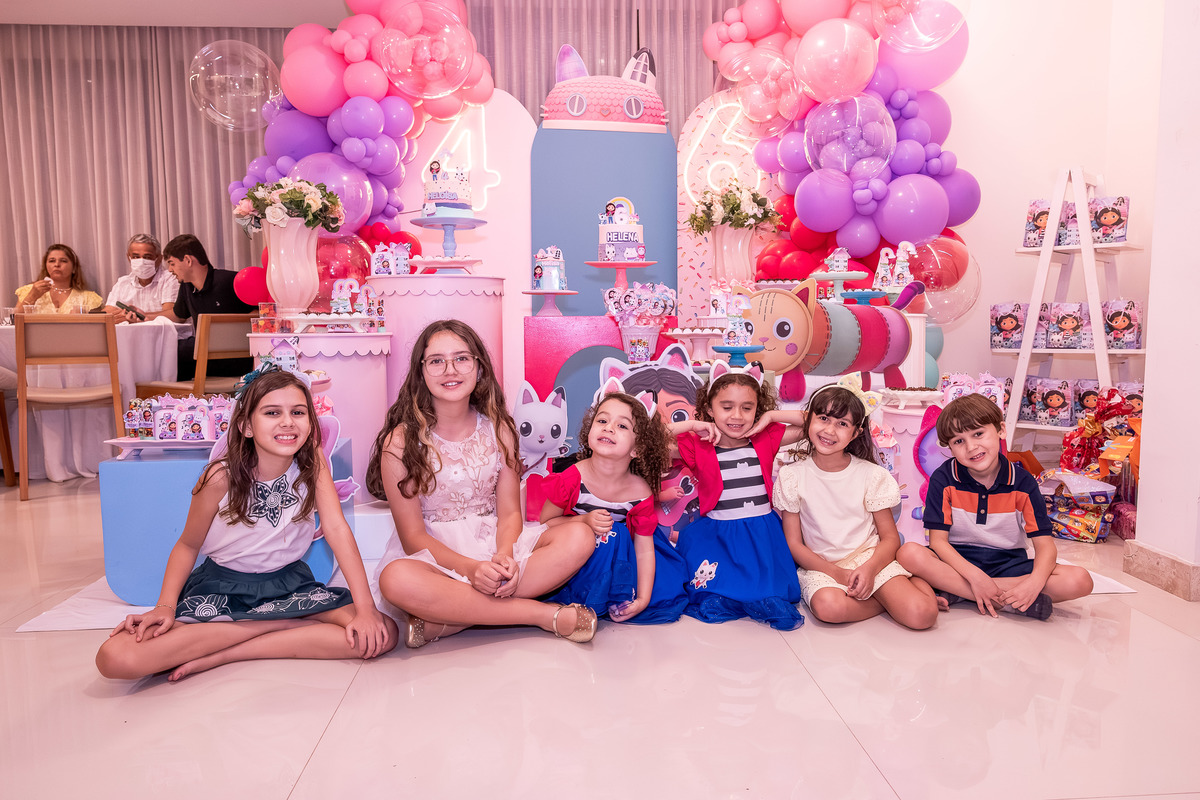 rupo de amigos de Helena e Heloísa se divertindo e interagindo na celebração.