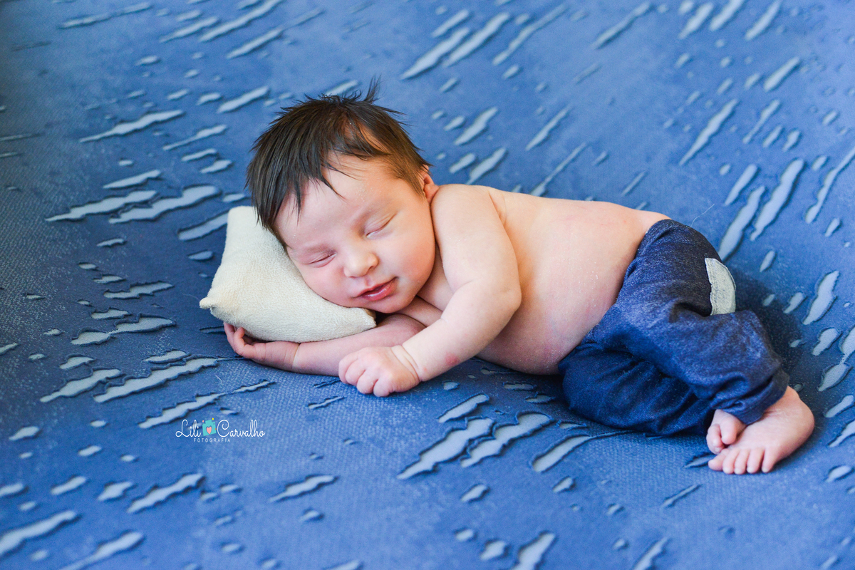 ensaio newborn realizada em estudio em Maringá, recem nascido menino calca jeans 
