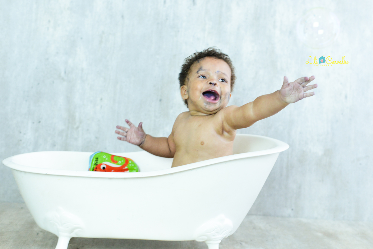 Ensaio fotografico de smash the cake em Maringá tentando pegar bolinha 