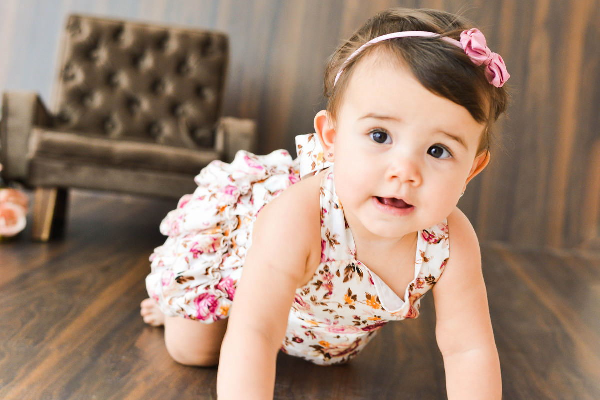 fotografia mensal de  menina em Maringá, menina sentada em sofa, engatinhando 