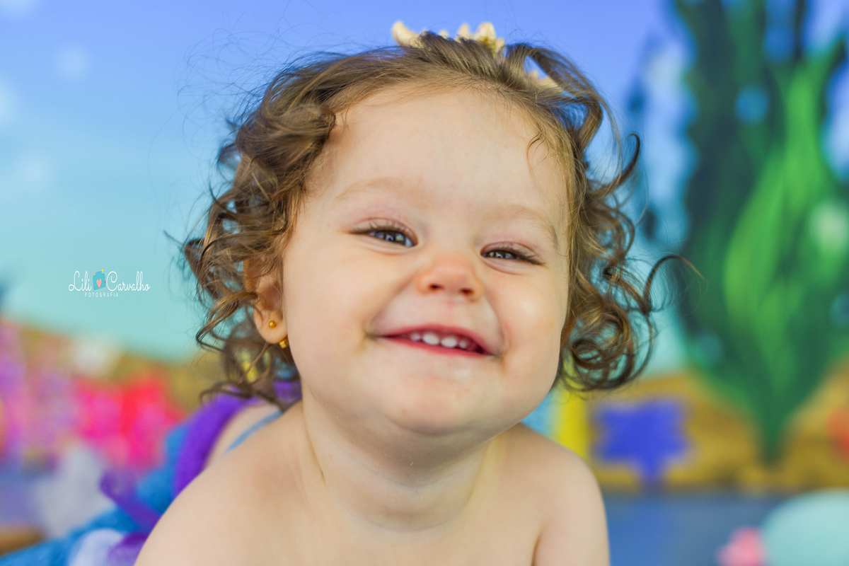 bebê mostrando os dentes na foto, foto em maringá